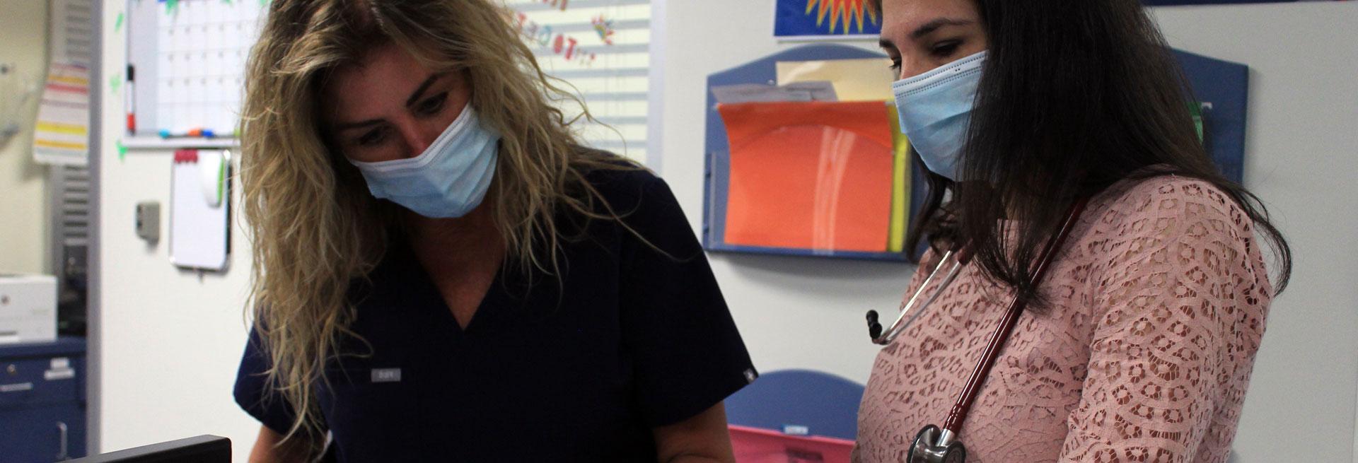 Doctor in the Student Health office with a nurse